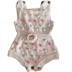 Knit playsuit with Pom Pom’s